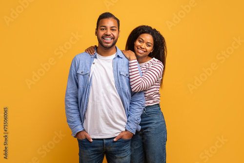 Happy Couple. Smiling Black Man And Woman Posing Over Yellow Background