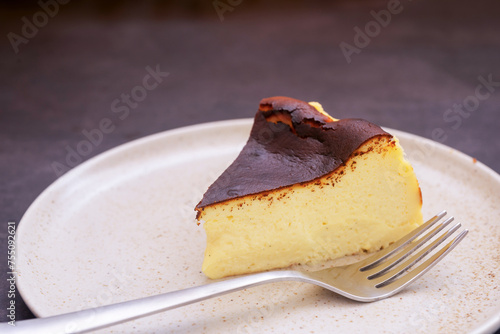 Homemade sliced baked Basque Burnt Cheesecake in ceramic plate