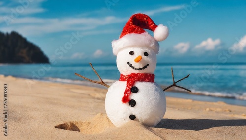 christmas snowman in santa hat at sandy beach