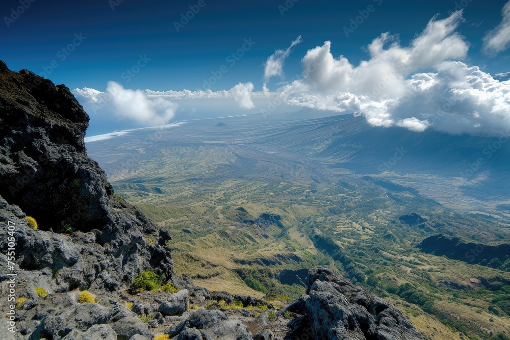 view from the top of a high mountain peak overlooking an expansive landscape below