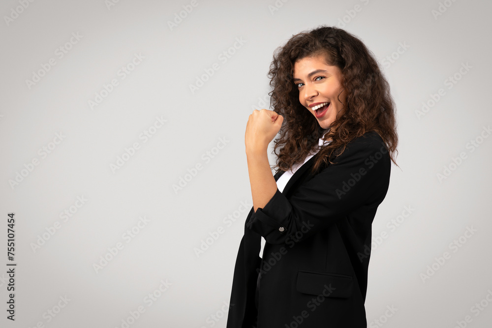 Joyful businesswoman with victorious fist pump, copy space Joyful businesswoman with victorious fist pump, copy space