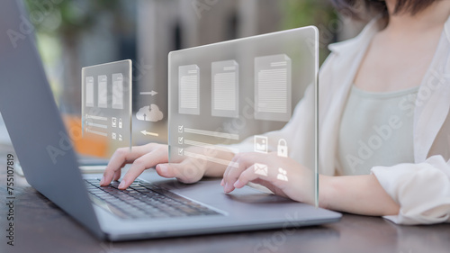 Businesswomen transferring backup business data to the cloud, Backup data to the cloud, Backing up data in multiple locations to prevent data loss, Accessing information through the network.