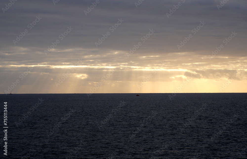 The sunrays through the clouds in the evening in Indian Ocean, Reunion island The sunrays through the clouds in the evening in Indian Ocean, Reunion island