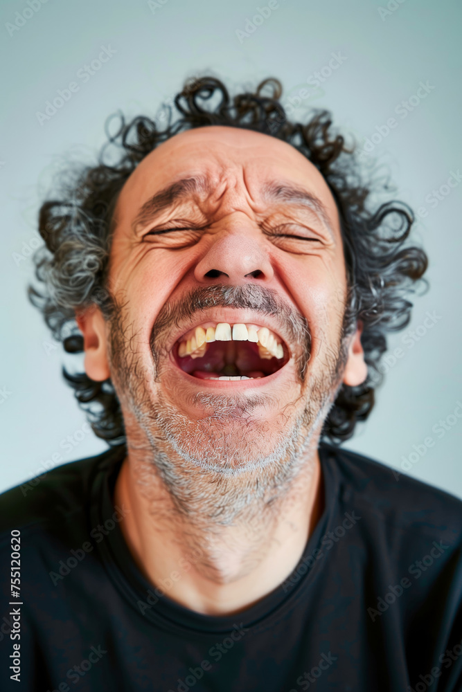 A caucasian man laughing wildly