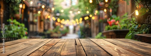 Wooden tabletop in focus with a vibrant, bokeh light background in a cozy outdoor cafe setting, perfect for dining or social gathering themes. © DailyStock