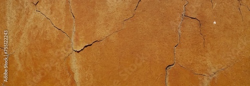 Texture of a cracked orange wall, panoramic banner. Wall background. copy space