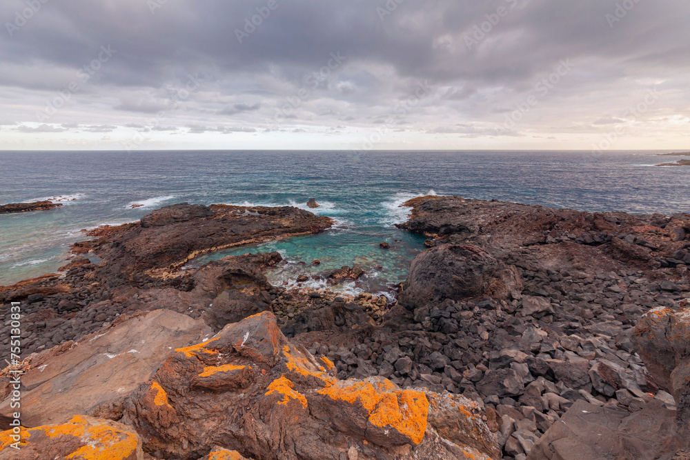 Stone coast with cliffs of the Atlantic Ocean at sunrise. Tenerife. Canary Islands, Spain Stone coast with cliffs of the Atlantic Ocean at sunrise. Tenerife. Canary Islands, Spain