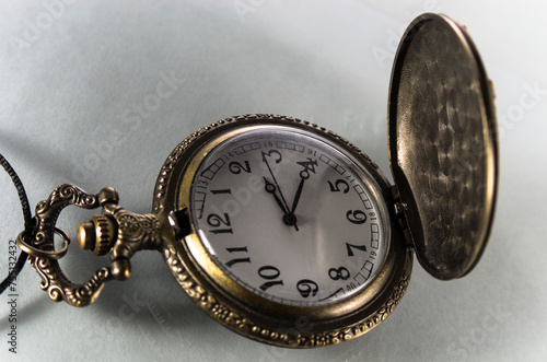 Single vintage pocket watch on white background
