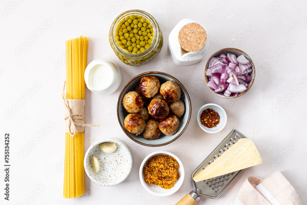 Ingredients for cooking spaghetti pasta with meatballs in cream sauce. Ingredients for cooking spaghetti pasta with meatballs in cream sauce.