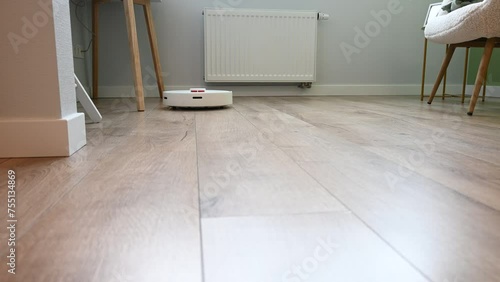 Modern robotic vacuum cleaner cleans the floor. Automatic House Cleaning. Smart home with automated devices that simplify life.