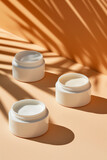 still life of cosmetic cream containers with a peach background