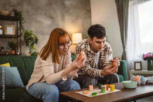 Sticker young man and woman couple or brother and sister paint easter eggs