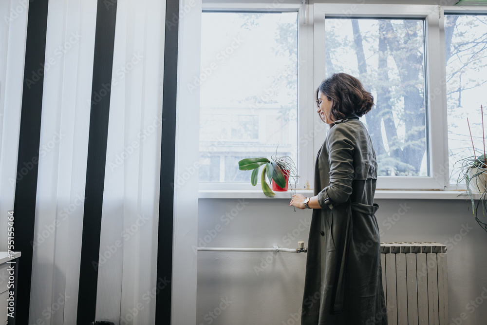 Elegant businesswoman smiling by the window in modern office. Elegant businesswoman smiling by the window in modern office.