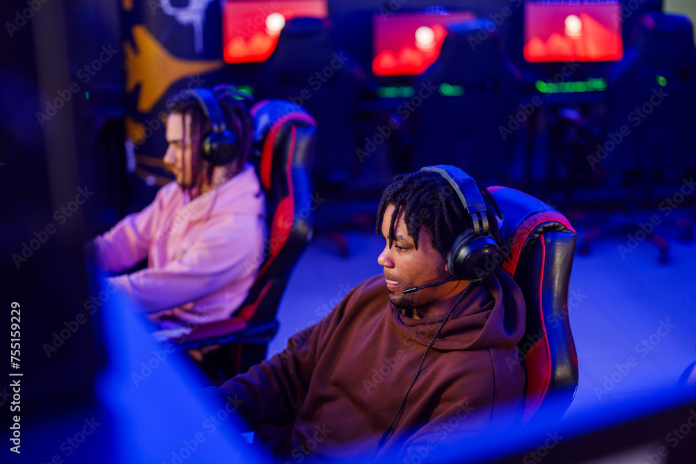 African american man gamer concentrating while playing online video game African american man gamer concentrating while playing online video game