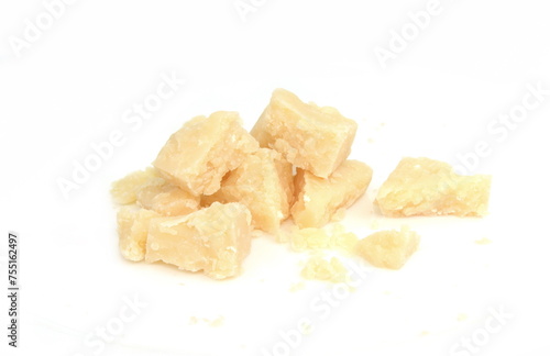 Pieces of parmesan cheese isolated on white background. Parmesan crumbs on white. 