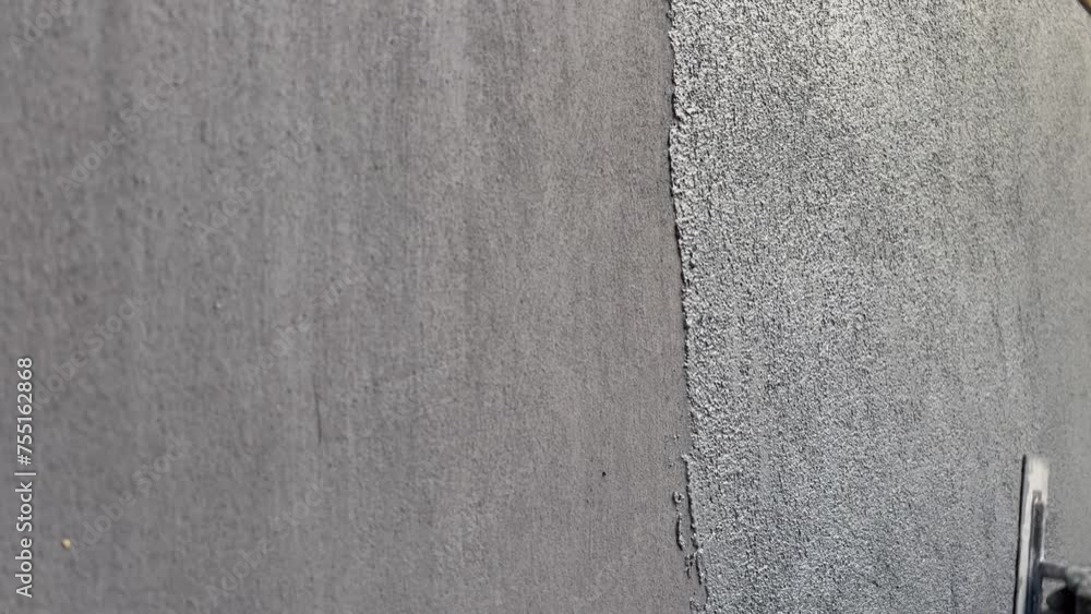 Repair and apply decorative plaster at home yourself using marble plaster. Do-it-yourself maintenance and repair of residential buildings. Plaster is dark gray with a fine mosaic background. Repair and apply decorative plaster at home yourself using marble plaster. Do-it-yourself maintenance and repair of residential buildings. Plaster is dark gray with a fine mosaic background.