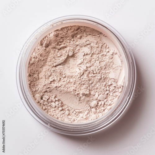 Loose powder contained in a transparent jar, typically used in cosmetics