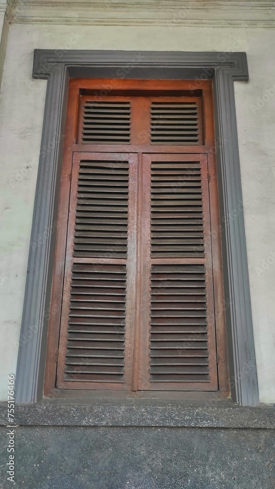 An old closed wooden vintage window in the old train station 
