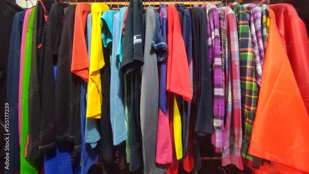 Kinds of clothes displayed in the rack to make the customers easier to choose the clothes 