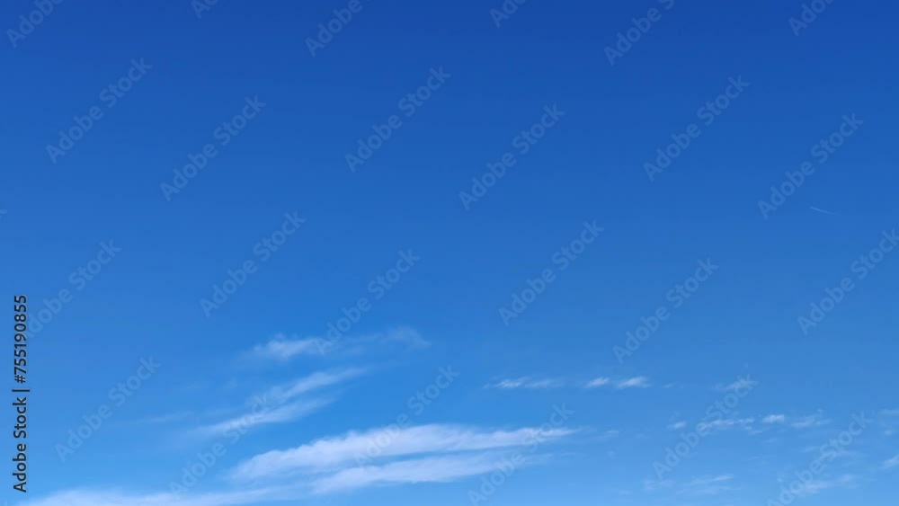 Small cirrus clouds move across the blue sky in the morning Small cirrus clouds move across the blue sky in the morning