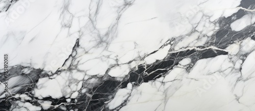 This black and white marble wall features a natural pattern texture  perfect for use in interiors as a tile or wallpaper for a luxurious design.