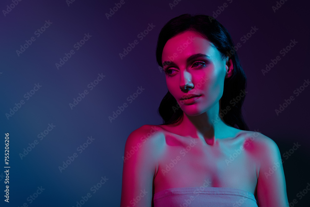 Photo of woman look aside empty space under pink neon illumination isolated bright dark color background Photo of woman look aside empty space under pink neon illumination isolated bright dark color background