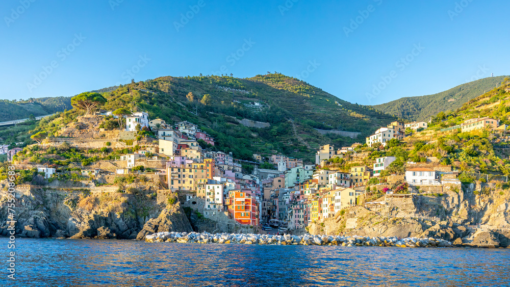 Riomaggiore, Italy - July 31, 2022: Panorama of the famous Italian seaside village Riomaggiore, Cinque Terre, Italy