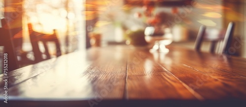 A blurred depiction of a wooden dining table and chairs, showcasing a vintage Instagram filter effect. The table and chairs are indistinct, adding a touch of nostalgia to the scene. © TheWaterMeloonProjec