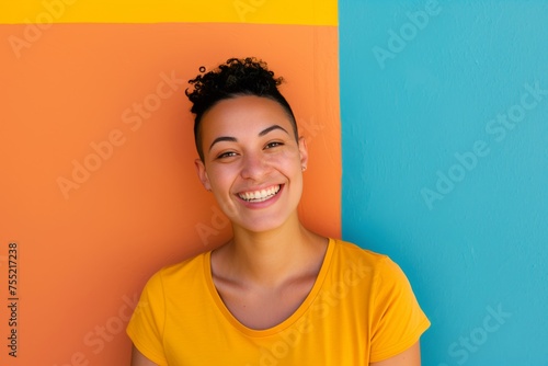 Happy hispanic lesbian young woman looking at the camera on a colorful background © Adriana