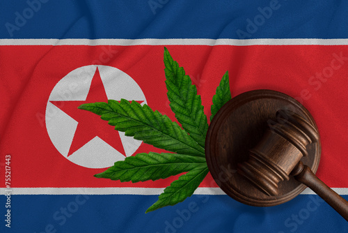 Gavel and cannabis leaf on the North Korea flag - legalization of marijuana concept