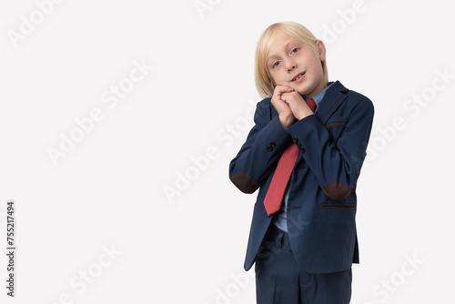 Portrait of a little boy in a business suit and red tie with copy space