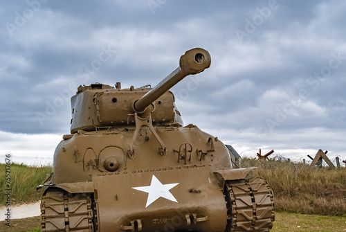 An American World War 2 M4 Sherman tank is facing the sunset on Utah beach, Normandy, France.