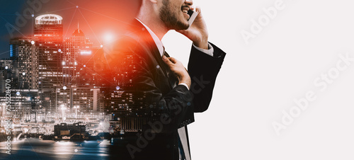 Double Exposure Image of Business Communication Network Technology Concept - Business people using smartphone or mobile phone device on modern cityscape background. uds