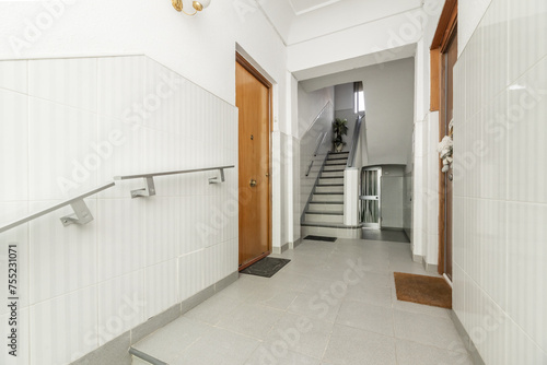 Access portal to a residential apartment building with tiled walls and