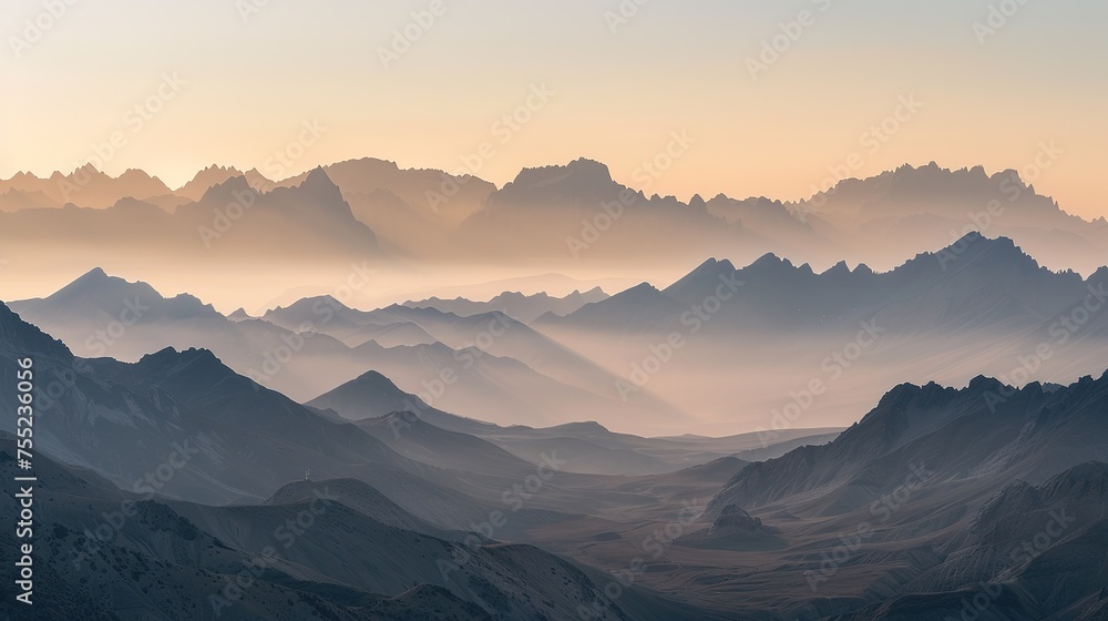 A majestic landscape of a mountain range at dawn, with the first light casting golden hues over the peaks. The Sony A7R IV's 61-megapixel sensor should capture the intricate details of the rugged 