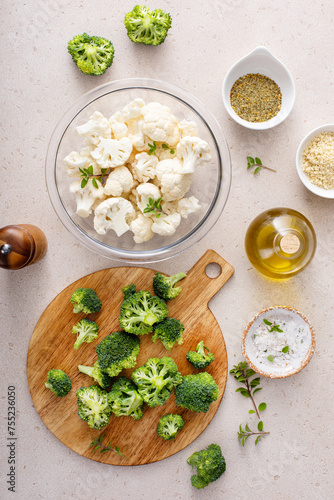 Cooking with broccoli and cauliflower, getting ready to roast vegetables with spices and olive oil
