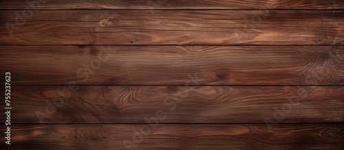 A close-up view of a wooden wall with a dark coffee brown stain covering its surface. The wood texture is visible through the stain, creating a rich and warm appearance.