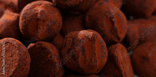 Closeup of pile of delicious chocolate truffles in cocoa powder. Food background.. photo