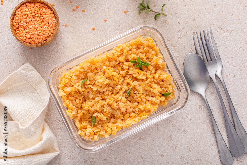 Cooked red lentils in a meal prep container, healthy vegan protein source
