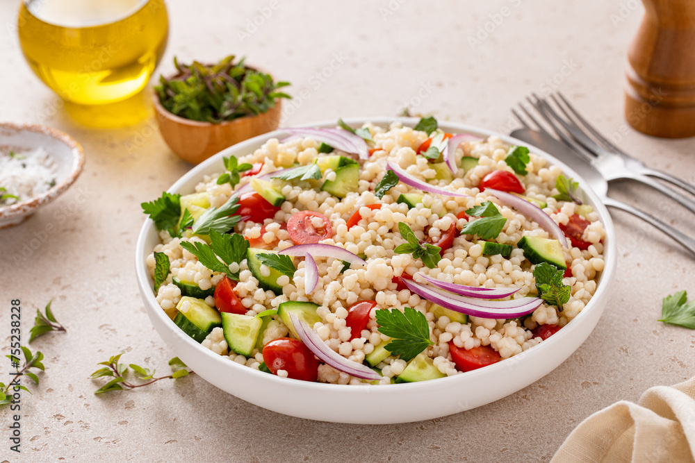 Pearl couscous salad with fresh vegetables and herbs, healthy side dish idea Pearl couscous salad with fresh vegetables and herbs, healthy side dish idea