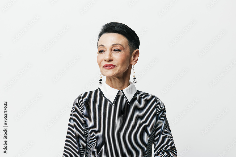 Portrait of a stylish young woman with short hair wearing a gray shirt, standing against a white background Portrait of a stylish young woman with short hair wearing a gray shirt, standing against a white background