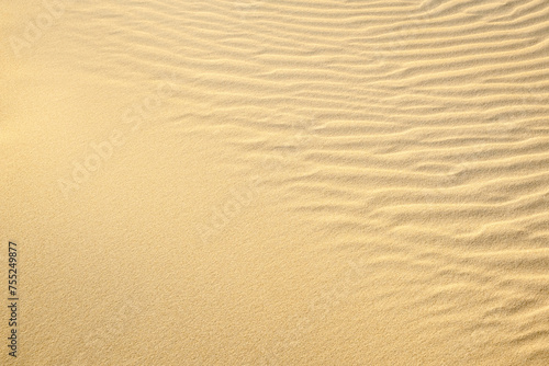 Waves of sand in dune. Texture Background of clean yellow sand on windy desert or beach.