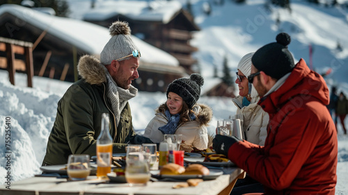Family having fun in winter, having lunch in the snow at ski resort in the mountain, happy to be on vacation, they eat and drink near the ski slopes, smiling, joyful, enjoying this moment together