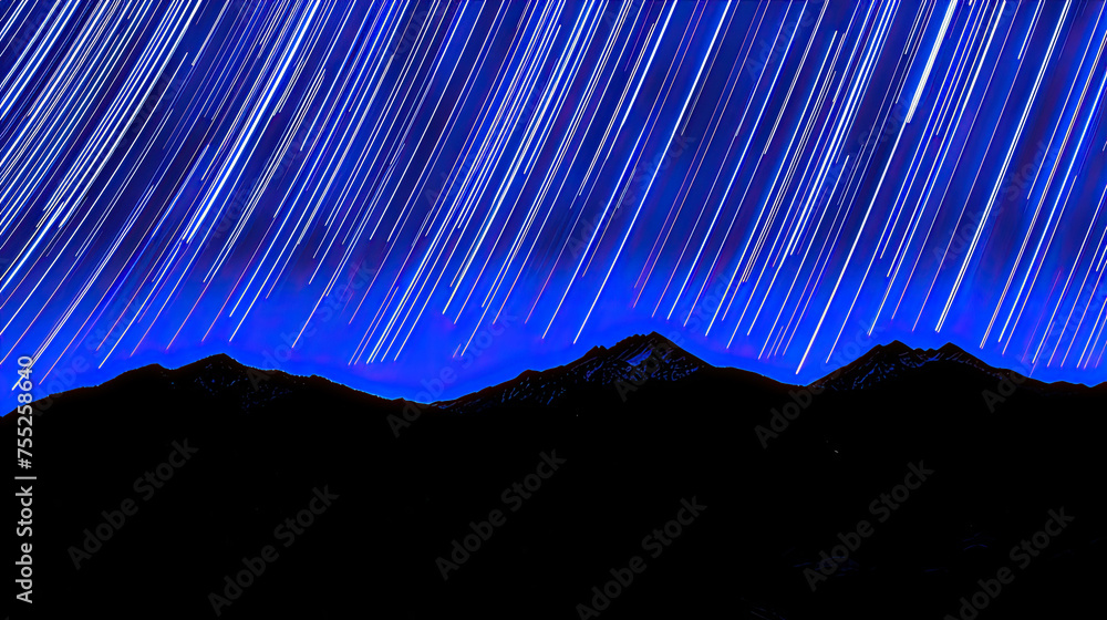 Long exposure night sky shot capturing striking star trails above a ...