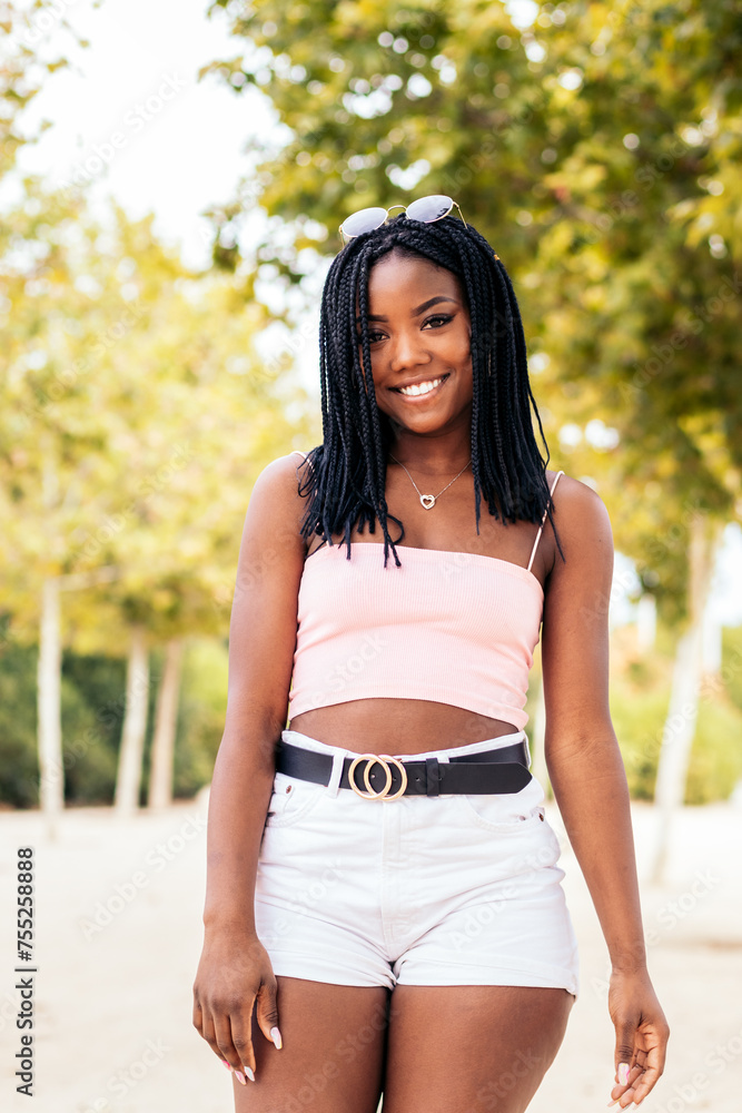 Portrait of an African American woman with braids in a park in summer