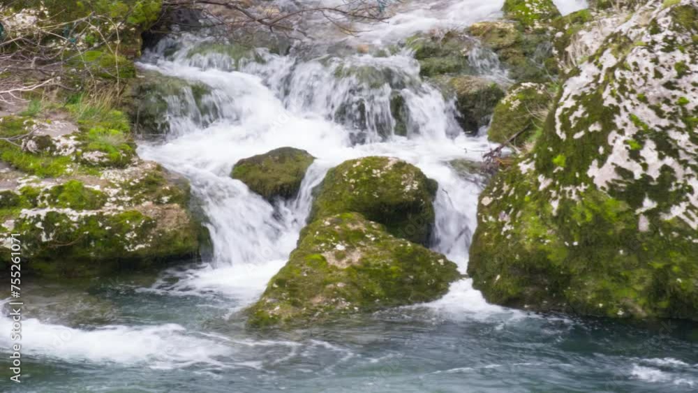 Water stream flowing on green mossy stones - mountain landscape with waterfall brook cascades. Natural resource conservation and environmental protection. Water stream flowing on green mossy stones - mountain landscape with waterfall brook cascades. Natural resource conservation and environmental protection.