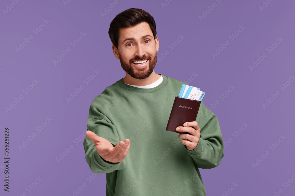 Smiling man with passport and tickets on purple background Smiling man with passport and tickets on purple background