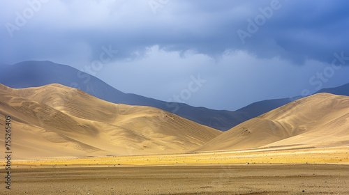 Dramatic desert landscape under a stormy sky with sunlight highlighting golden sand dunes against dark mountain silhouettes