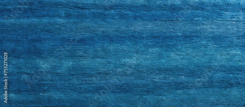 A blue rug is displayed against a simple white backdrop. The rugs texture adds depth to the scene, making it suitable for interior wallpaper or a cover page.