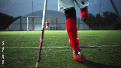 Legs of disabled football plaer with ball and crutches photo